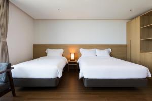 Postel nebo postele na pokoji v ubytování Lemain Hotel