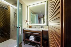 a bathroom with a sink and a mirror at Hard Rock Hotel Desaru Coast in Desaru