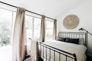a bedroom with a bed and a large window at Braebrook Stunning farm house in Upper Kangaroo River