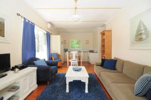 a living room with a couch and a coffee table at Love Shack 1 bedroom cosy cottage in Upper Kangaroo River