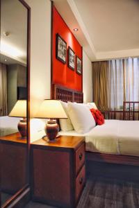 a hotel room with two beds and a mirror at Butterfly on Wellington, Central in Hong Kong