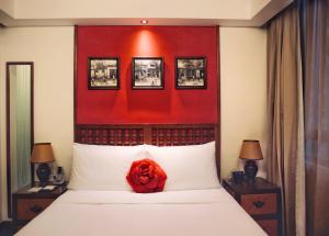 a bedroom with a bed with a red head board at Butterfly on Wellington, Central in Hong Kong