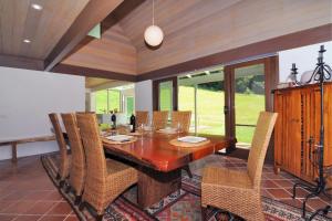 a dining room with a wooden table and chairs at Yeola Lush location with river access in Upper Kangaroo River +10 photos