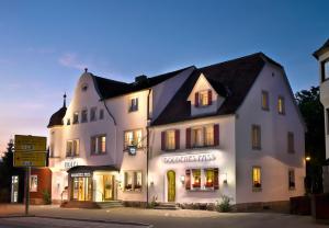 a white building on the corner of a street at TOP Hotel Goldenes Fass in Rothenburg ob der Tauber