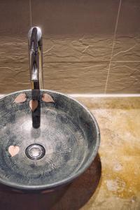 a bathroom sink with a faucet at Butterfly on Wellington, Central in Hong Kong