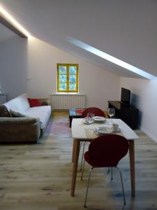 a living room with a table and a couch at Apartment Abinkar in Tolmin