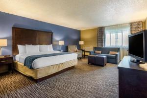 a hotel room with a bed and a television at Suburban Studios Arlington Heights Elk Grove in Arlington Heights