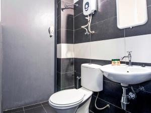 a bathroom with a toilet and a sink at Intime Hotel Kuchai Lama Kuala Lumpur in Kuala Lumpur