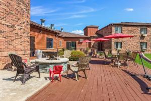 a patio with chairs and a table and umbrella at Quality Inn Petoskey-Harbor Springs in Petoskey