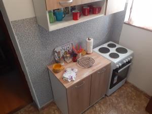 a small kitchen with a counter and a stove at Apartman Došen in Ličko Petrovo Selo +12 photos