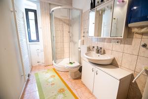 a bathroom with a sink and a toilet and a shower at Cvet gora - Camping, Glamping and Accomodations in Zgornje Jezersko