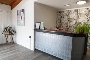 a reception desk in a room with a wall at Lantern Motor Inn in Mackay