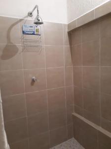 a bathroom with a shower with a tile wall at Martha´s HOUSE in Culiacán