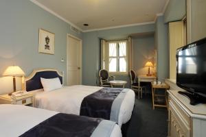 Postel nebo postele na pokoji v ubytování Hotel Monterey Osaka