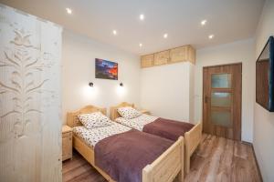 Кровать или кровати в номере Apartament Przytulny