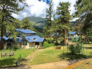 un gruppo di case con montagne sullo sfondo di Riversong Inn Retreat a Estes Park