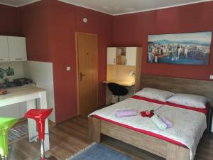 a bedroom with a bed with a painting on the wall at City Break Studio Apartment in Zagreb