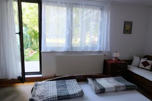 a bedroom with a bed and a large window at Ammy apartment in Sarajevo