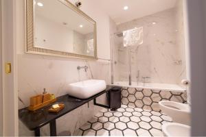 a bathroom with a sink and a toilet and a mirror at The Duomo House by House In Naples in Naples +35 photos
