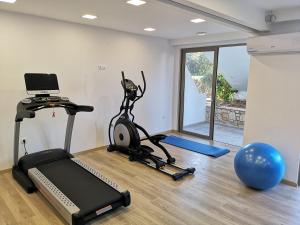 a gym with a treadmill and a exercise bike at Dimitra Hotel in Hersonissos