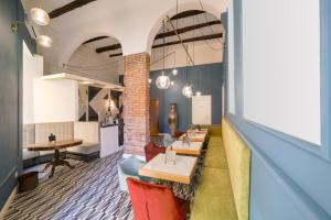 a restaurant with tables and chairs in a room at The Duomo House by House In Naples in Naples