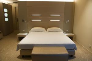 a bedroom with a bed and a large headboard at Best Western Plus Net Tower Hotel Padova in Padova
