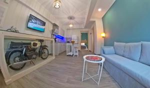a living room with a couch and a motorcycle on the wall at veraghi apartment 1 in Lefkada