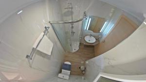 an overhead view of a bathroom with a shower and a sink at veraghi apartment 1 in Lefkada