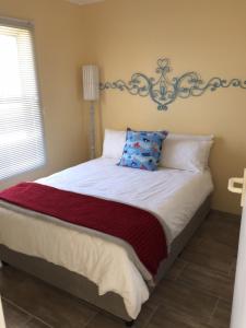 a bedroom with a large bed with a headboard at Huisi by di C in Hermanus