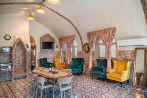 a living room with a table and chairs at The Dream Compound- by Biankini in Kalia