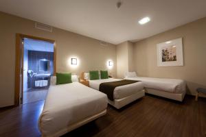 Llit o llits en una habitació de Vettonia Hotel