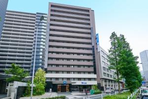 a large building with a lot of windows at ibis Budget Osaka Umeda in Osaka