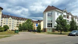 a row of apartment buildings on a street at Santariškės Apartment in Vilnius
