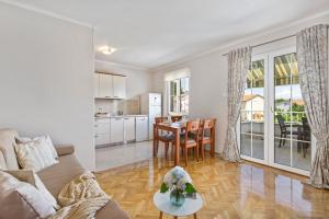a living room with a couch and a table at Apartman Ivan in Malinska