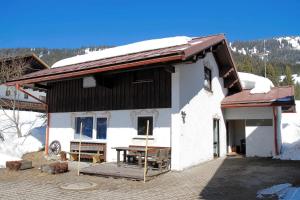 a house with a table in front of it at Ferienhaus Bausch in Balderschwang +22 photos