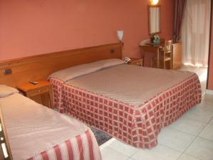 Postel nebo postele na pokoji v ubytování Hotel La Grotte