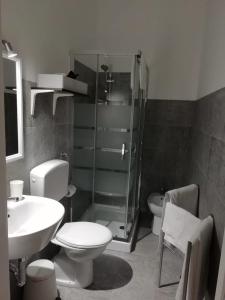 a bathroom with a toilet and a sink at Fontanarossa Airport Home in Catania