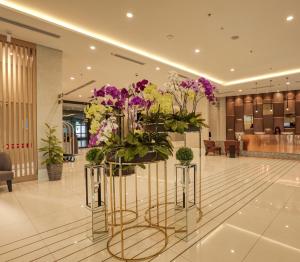 a large display of flowers in a lobby at Mercure Living Putrajaya in Putrajaya