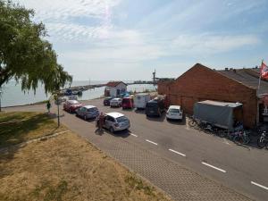 a group of cars parked on the side of a road at Zunda in Nida