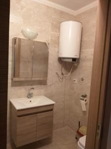 a bathroom with a sink and a toilet at GÜMÜLDÜR ÇALIŞKAN APART 1 in Gumuldur +25 photos
