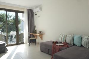 a living room with a couch and a table at Acrotel Elea Beach in Elia