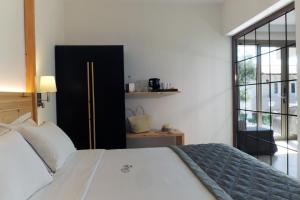 a bedroom with a bed and a large window at Acrotel Elea Beach in Elia