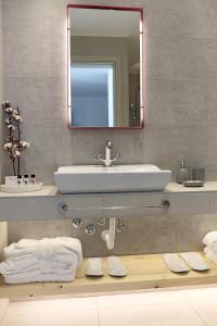 a bathroom with a sink and a mirror at Acrotel Elea Beach in Elia