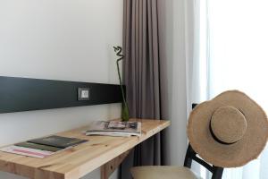 a desk with a hat sitting next to a window at Acrotel Elea Beach in Elia