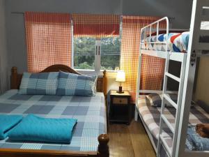 a bedroom with two bunk beds and a ladder at Muster Guesthouse in Phra Nakhon Si Ayutthaya