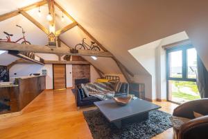 a living room with a couch and a table at Ecolodges de Loire & Spa in Gennes