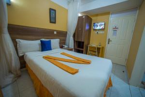 Postel nebo postele na pokoji v ubytování Eureka Place Hotel Kampala