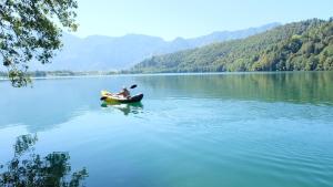 a man in a boat on a lake at Hotel Liberty in Levico Terme +80 photos