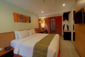 Postel nebo postele na pokoji v ubytování Savvoya Hotel Seminyak