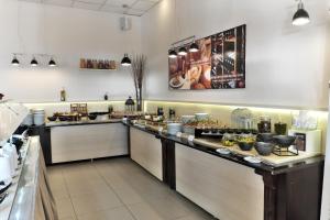 a kitchen with a counter with food on it at Acrotel Elea Beach in Elia